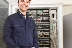 Technician in front of a network rack