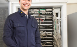 Technician in front of a network rack
